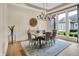 Elegant dining room with modern chandelier and views of the outdoors at 12839 Bird Cage, Carmel, IN 46032