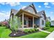 Charming blue two-story home with landscaped yard and inviting front porch at 12839 Bird Cage, Carmel, IN 46032