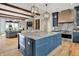 Open concept kitchen with blue cabinets, granite countertops and hardwood floors at 12839 Bird Cage, Carmel, IN 46032
