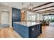 Modern kitchen with a large island, granite countertops and stylish pendant lighting at 12839 Bird Cage, Carmel, IN 46032