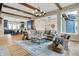 Spacious living room with hardwood floors, beamed ceiling and seamless connection to kitchen at 12839 Bird Cage, Carmel, IN 46032