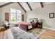 Inviting bedroom with wood beams, a large window, a patterned rug, and hardwood floors at 12839 Bird Cage, Carmel, IN 46032