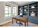 Well-lit office with built-in bookshelves, a wooden desk, large windows, and hardwood floors at 12839 Bird Cage, Carmel, IN 46032