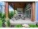 Covered outdoor patio features a stone fireplace and comfortable seating area at 12839 Bird Cage, Carmel, IN 46032