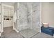 Modern shower with marble tile, a glass enclosure, and a built-in bench, next to closet at 12839 Bird Cage, Carmel, IN 46032