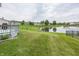 Lush backyard overlooking a pond with a fountain creates a serene outdoor space at 12880 Oxbridge Pl, Fishers, IN 46037