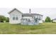 Home exterior showcasing a wooden deck with outdoor seating and a manicured lawn at 12880 Oxbridge Pl, Fishers, IN 46037