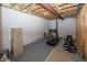 Unfinished basement area, ready for customization, features exposed ceiling and exercise equipment at 12880 Oxbridge Pl, Fishers, IN 46037