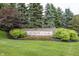 Stone sign marking the entrance to Avalon of Fishers, beautifully landscaped with greenery and flowers at 12880 Oxbridge Pl, Fishers, IN 46037