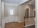 Welcoming foyer with hardwood floors, traditional wainscoting, and staircase to the second level at 12880 Oxbridge Pl, Fishers, IN 46037