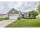 Charming single-story home with stone accents, well-maintained lawn, and attached two-car garage at 12880 Oxbridge Pl, Fishers, IN 46037