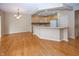 Open-concept living space with adjacent dining and kitchen, featuring an island with counter seating at 12880 Oxbridge Pl, Fishers, IN 46037