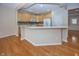 Bright eat-in kitchen with island, breakfast bar, ample wood cabinetry and stainless appliances at 12880 Oxbridge Pl, Fishers, IN 46037
