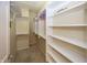 This walk-in closet is complete with custom shelving and ample storage space at 12880 Oxbridge Pl, Fishers, IN 46037