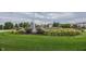 Well maintained water feature in a neighborhood with a lush green lawn and landscaping at 12880 Oxbridge Pl, Fishers, IN 46037