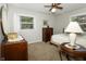 Cozy bedroom featuring a ceiling fan, neutral walls, and a window letting in natural light at 13 Fairlane Dr, Brownsburg, IN 46112