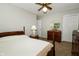 This bedroom has carpeted floors and is illuminated by a ceiling fan and natural light from the window at 13 Fairlane Dr, Brownsburg, IN 46112