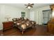 Bedroom featuring ceiling fan, wood floors, and ensuite bathroom at 13 Fairlane Dr, Brownsburg, IN 46112