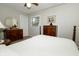 View of a bedroom featuring two dressers, a window and a ceiling fan with white linens on the bed at 13 Fairlane Dr, Brownsburg, IN 46112