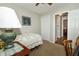 The bedroom has white walls and is illuminated by a ceiling fan, and a door leading to the hallway at 13 Fairlane Dr, Brownsburg, IN 46112