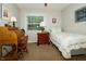 A comfy bedroom featuring a desk, bedside table and a bed with decorative pillows at 13 Fairlane Dr, Brownsburg, IN 46112