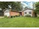 Charming brick home with a well-manicured lawn and flower beds at 13 Fairlane Dr, Brownsburg, IN 46112