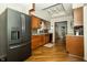 View of the kitchen featuring wood cabinets, granite countertops and adjoining dining area at 13 Fairlane Dr, Brownsburg, IN 46112