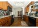 Updated kitchen with granite countertops, stainless appliances, and dark wood cabinets at 13 Fairlane Dr, Brownsburg, IN 46112