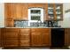 Updated kitchen with custom wood cabinetry, granite countertops, and mosaic backsplash at 13 Fairlane Dr, Brownsburg, IN 46112