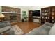 Cozy living room featuring a brick fireplace and hardwood flooring at 13 Fairlane Dr, Brownsburg, IN 46112