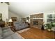 Spacious living room with a brick fireplace, hardwood floors and comfortable seating at 13 Fairlane Dr, Brownsburg, IN 46112