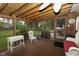 Relaxing screened porch featuring wood floors, ceiling fan, and view of the outdoor space at 13 Fairlane Dr, Brownsburg, IN 46112