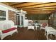 This screened porch features wicker furniture, a ceiling fan, and a view of the backyard at 13 Fairlane Dr, Brownsburg, IN 46112