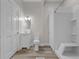 Bathroom featuring a sink and vanity, toilet, and shower-tub combo with white tiled surround at 1310 California St, Columbus, IN 47201