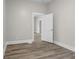 Bedroom with wood-look flooring and a white door with an open view to another room at 1310 California St, Columbus, IN 47201