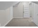 Neutral bedroom with carpet, slanted ceilings, and a door to another room at 1310 California St, Columbus, IN 47201