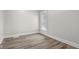Bright bedroom features wood-look flooring and a window for natural light at 1310 California St, Columbus, IN 47201