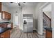 Spacious kitchen with stainless steel refrigerator, and wood-look flooring at 1310 California St, Columbus, IN 47201