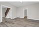 Spacious living room with modern floors, neutral walls, and staircase access at 1310 California St, Columbus, IN 47201