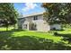 A well-manicured backyard with a patio, lush lawn, and mature trees at 13355 Freenza Ct, Carmel, IN 46074