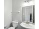 Well-lit bathroom with a toilet, sink, and vanity at 13355 Freenza Ct, Carmel, IN 46074