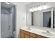 Bathroom featuring double sinks, shower, toilet and vanity with ample lighting at 13355 Freenza Ct, Carmel, IN 46074