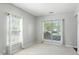 Bright bedroom featuring two large windows with sheer curtains and neutral carpeting at 13355 Freenza Ct, Carmel, IN 46074
