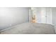Bedroom featuring neutral walls, carpet, closet, and a door that leads outside of the room at 13355 Freenza Ct, Carmel, IN 46074