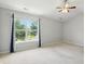 Bedroom features large window, ceiling fan, and light walls at 13355 Freenza Ct, Carmel, IN 46074
