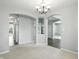 Open-concept dining room featuring a chandelier and views into adjacent rooms at 13355 Freenza Ct, Carmel, IN 46074