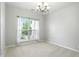 Light-filled dining room with a chandelier and a large window at 13355 Freenza Ct, Carmel, IN 46074