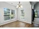Sun-lit dining room featuring new flooring and a modern chandelier at 13355 Freenza Ct, Carmel, IN 46074