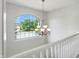 Hallway features a large window, wrought iron chandelier, and white trim at 13355 Freenza Ct, Carmel, IN 46074