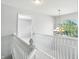 Second story hallway with chandelier and arched window at 13355 Freenza Ct, Carmel, IN 46074